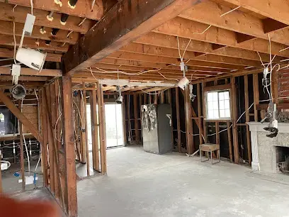 A room opened to the studs and joists so the framing can dry after water damage