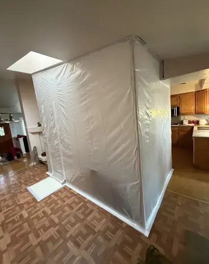 A containment tent built around a kitchen work area to hold dust and moisture