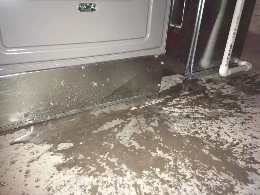 Condensate water spread across the floor under an AC unit in a Highland home