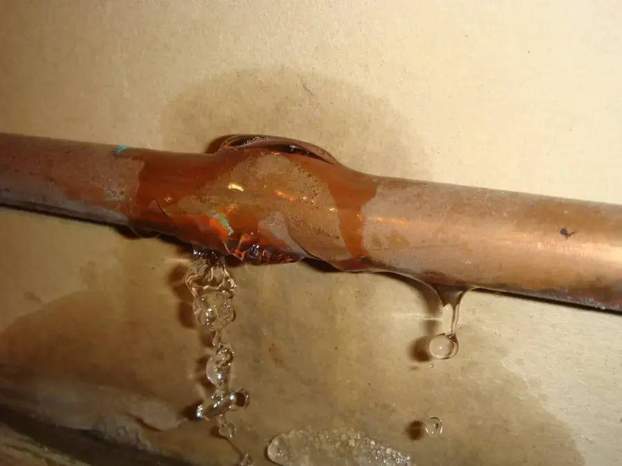 Water dripping from a split copper pipe during a Highland burst pipe leak